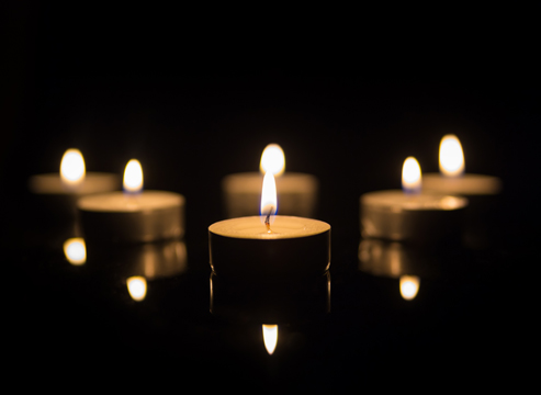 Tea Candles with Reflection on Black background