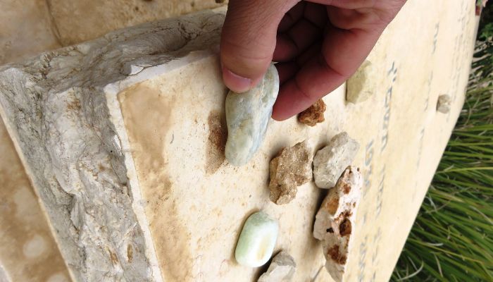 why do people put rocks on gravestones?